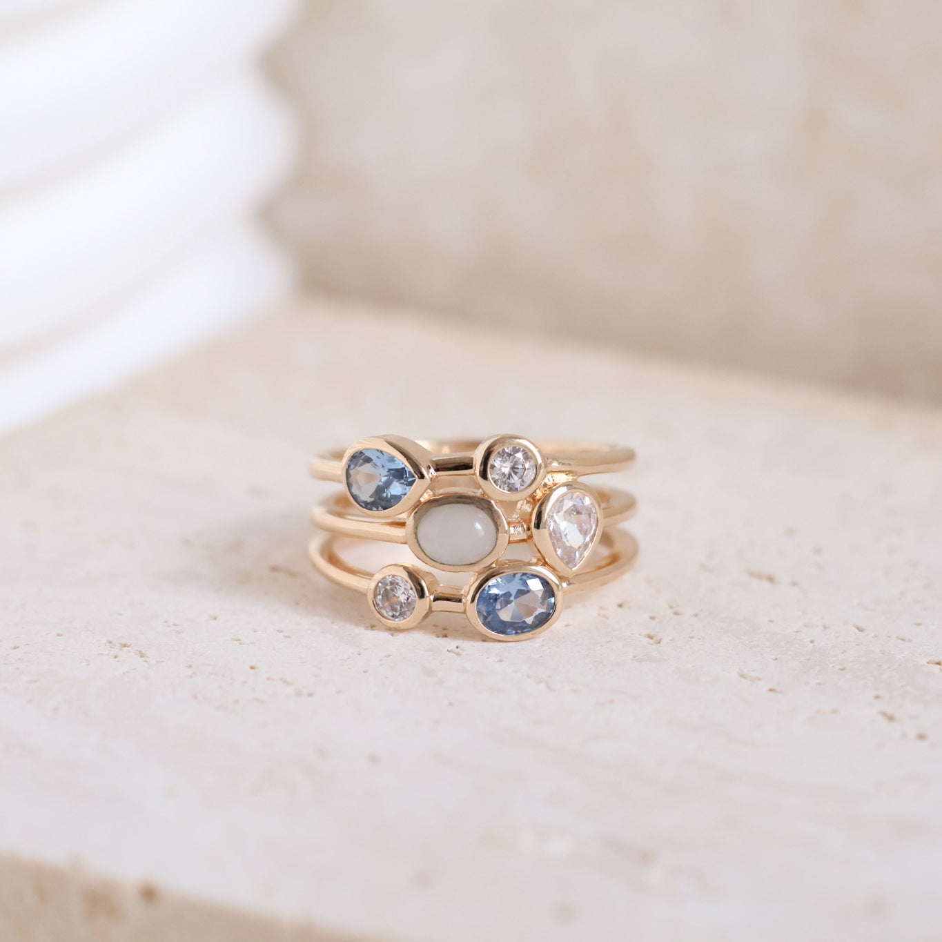 Three-row Anya ring with white and blue zircons gold plated