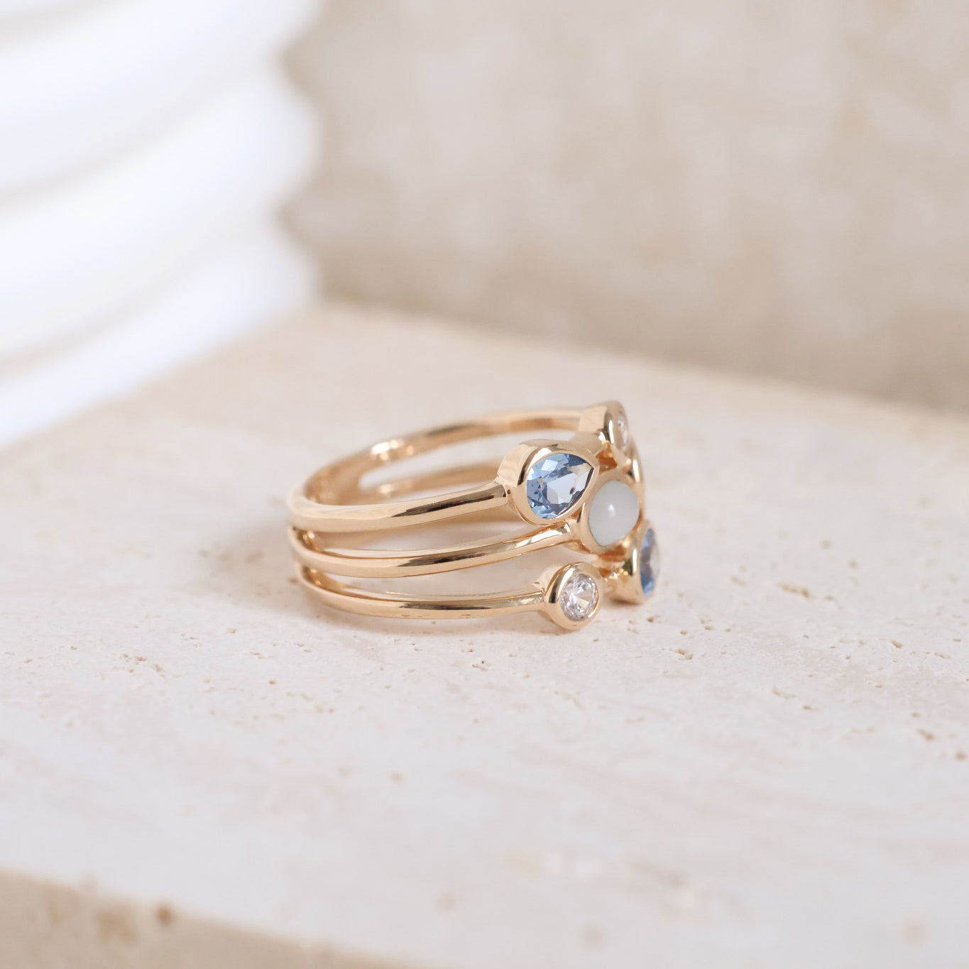 Three-row Anya ring with white and blue zircons gold plated