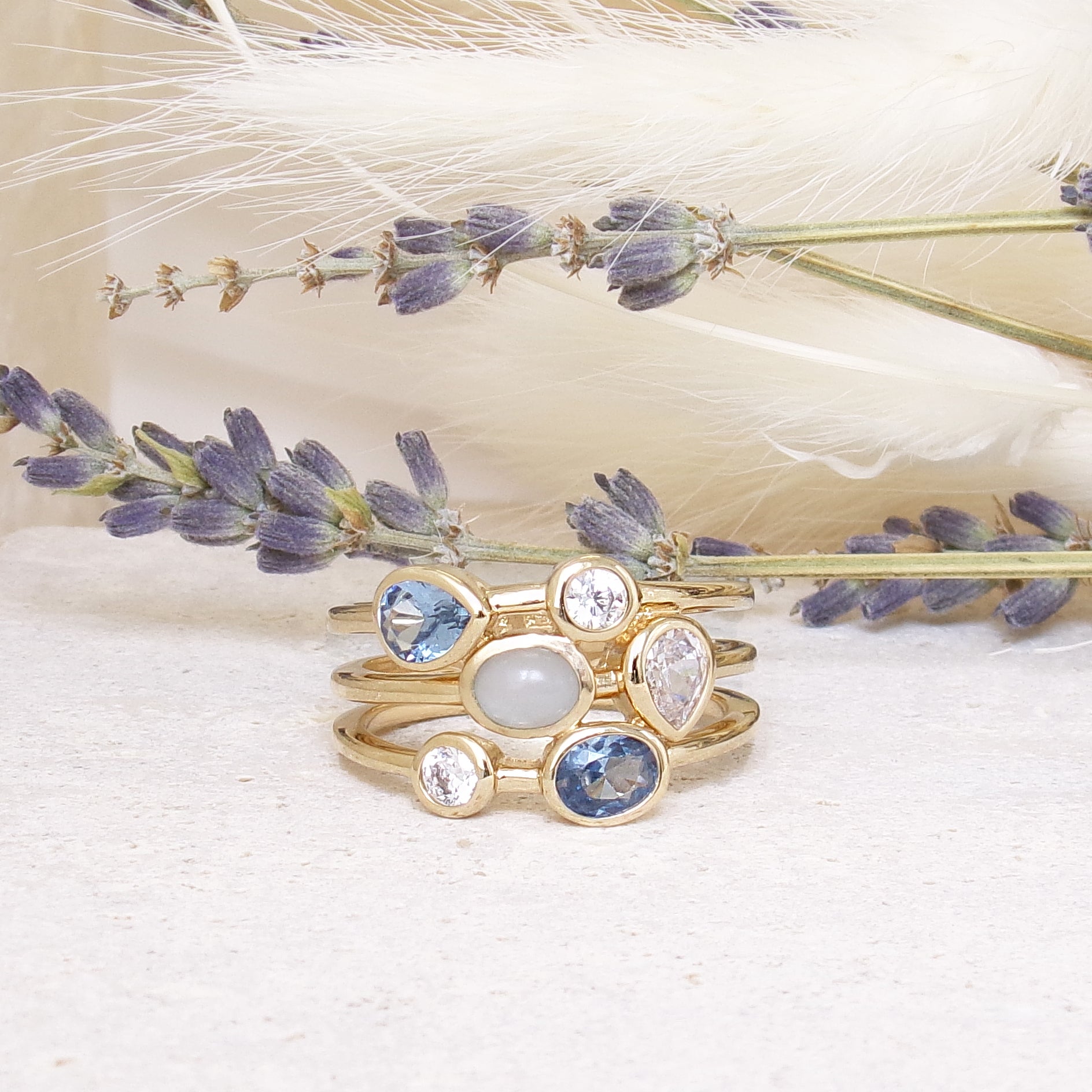 Three-row Anya ring with white and blue zircons gold plated