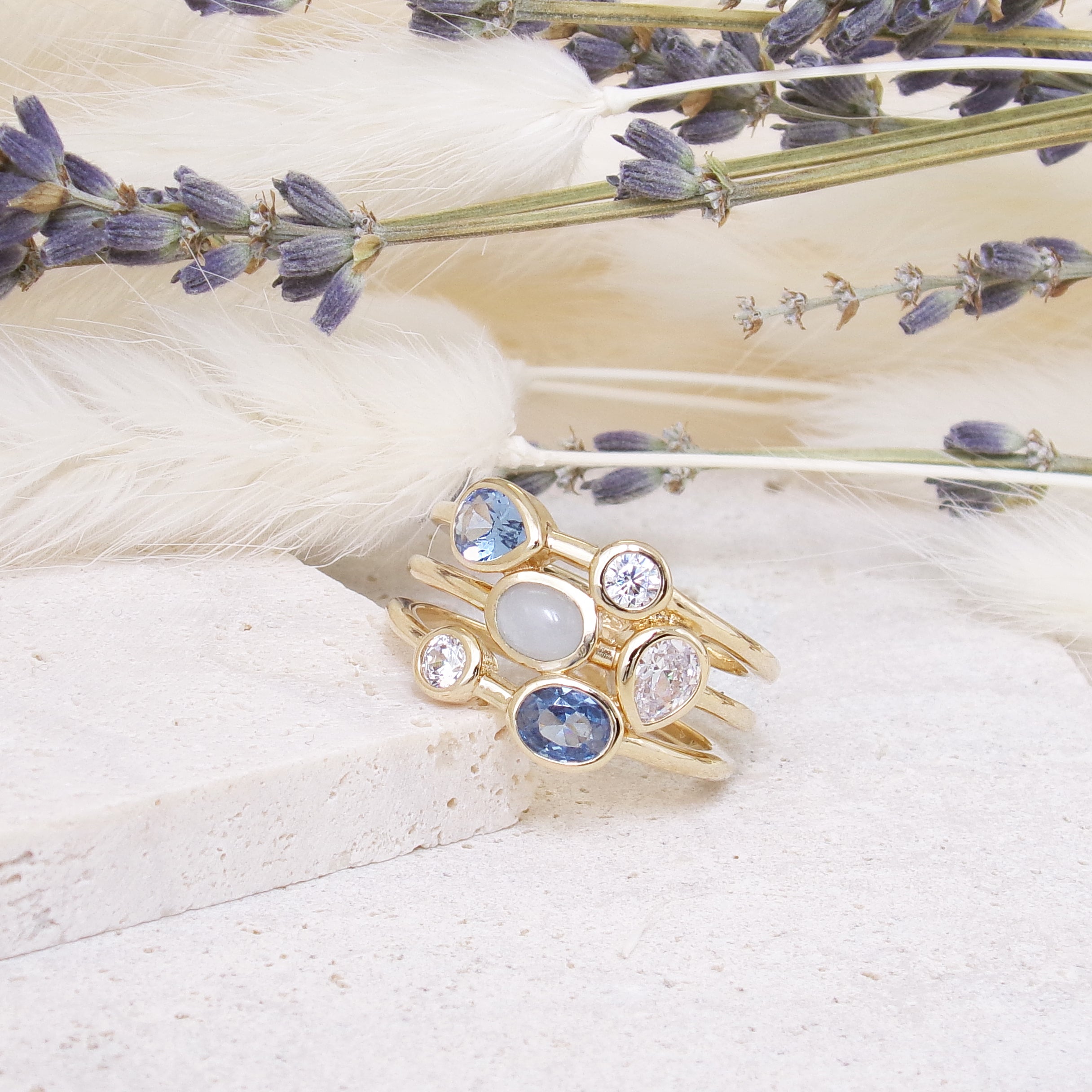 Three-row Anya ring with white and blue zircons gold plated