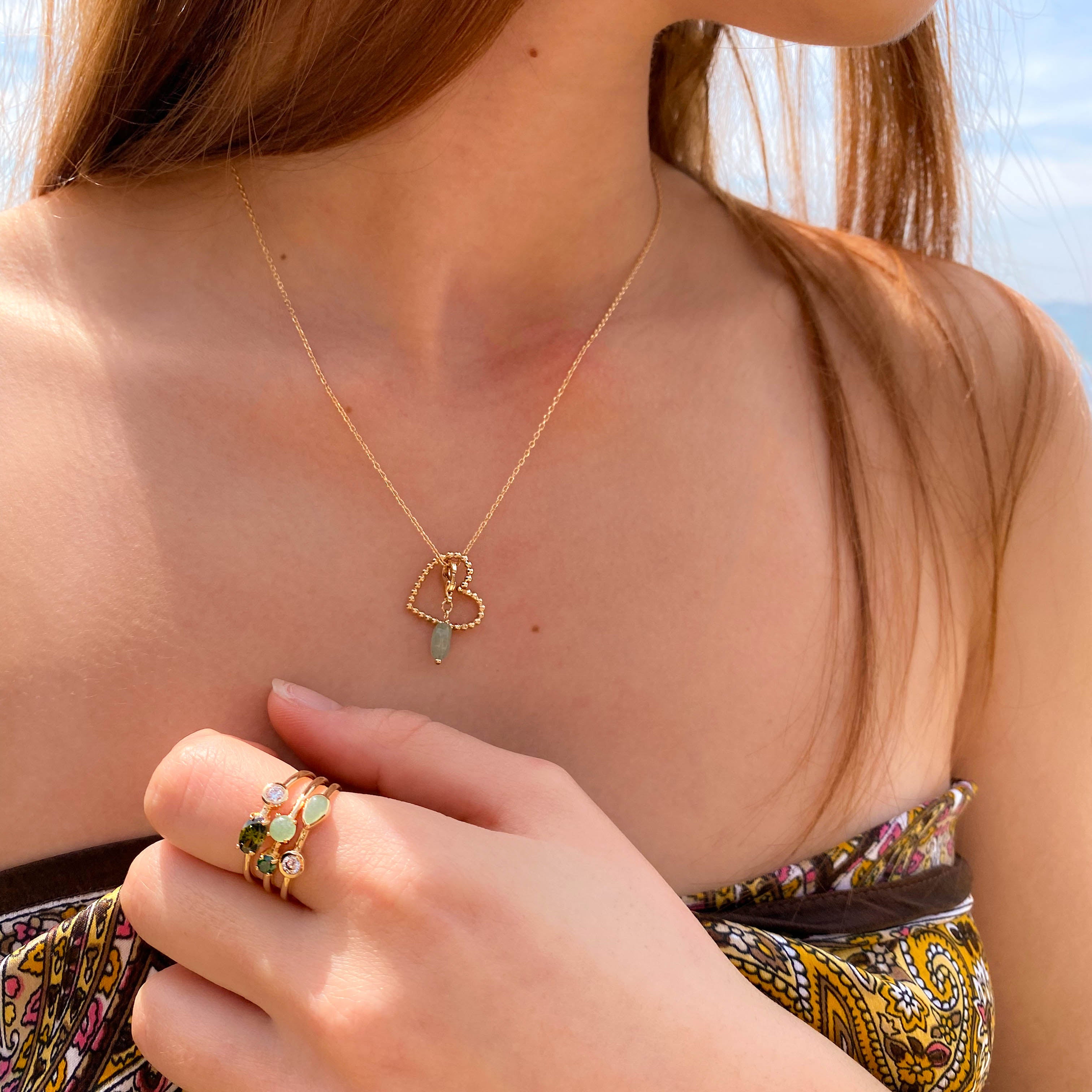 Anya ring three rows with white and green zircons gold plated