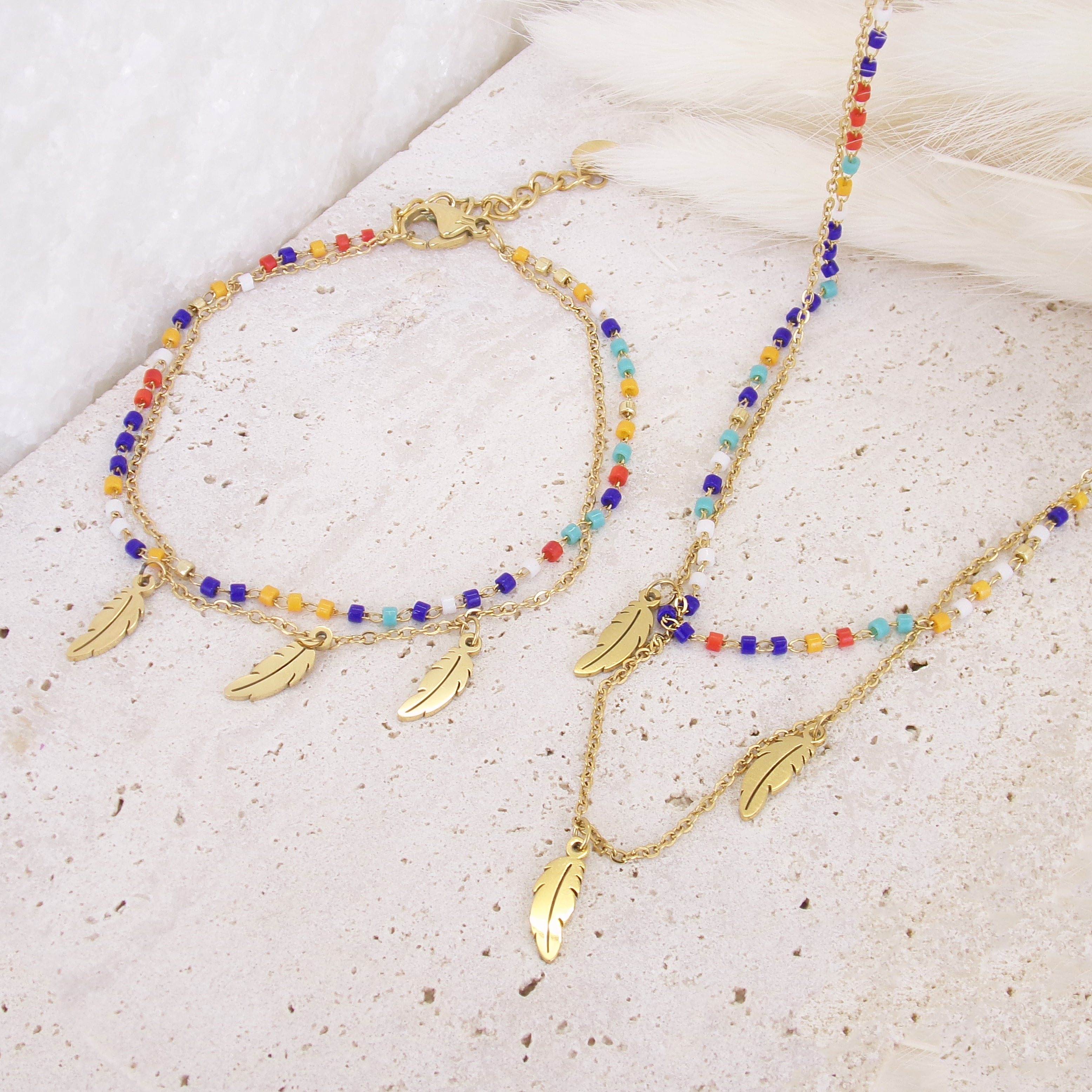 Sara double row bracelet with multicoloured pearls and feather pendants stainless steel