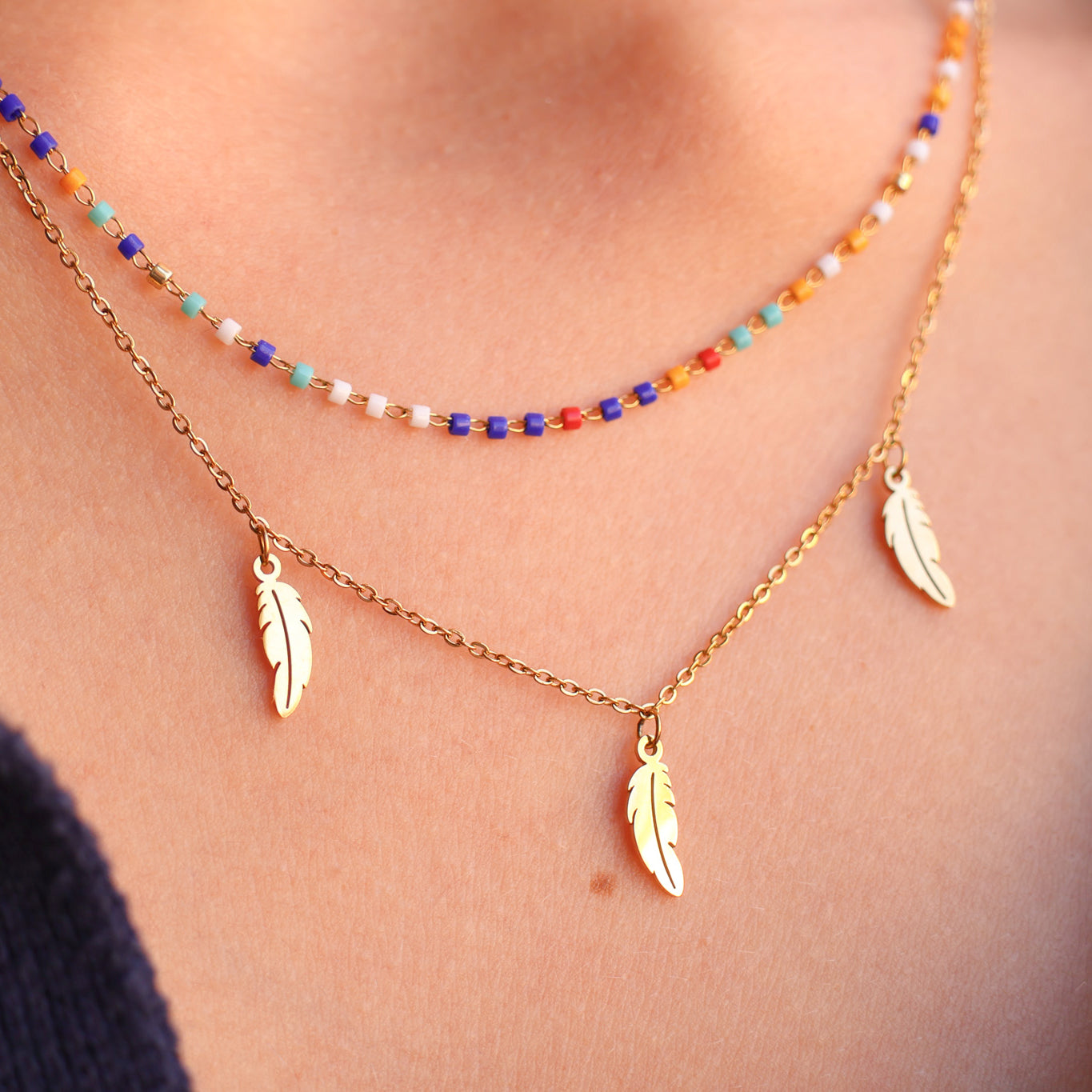 Double row Sara necklace with multicolored beads and stainless steel feather tassels