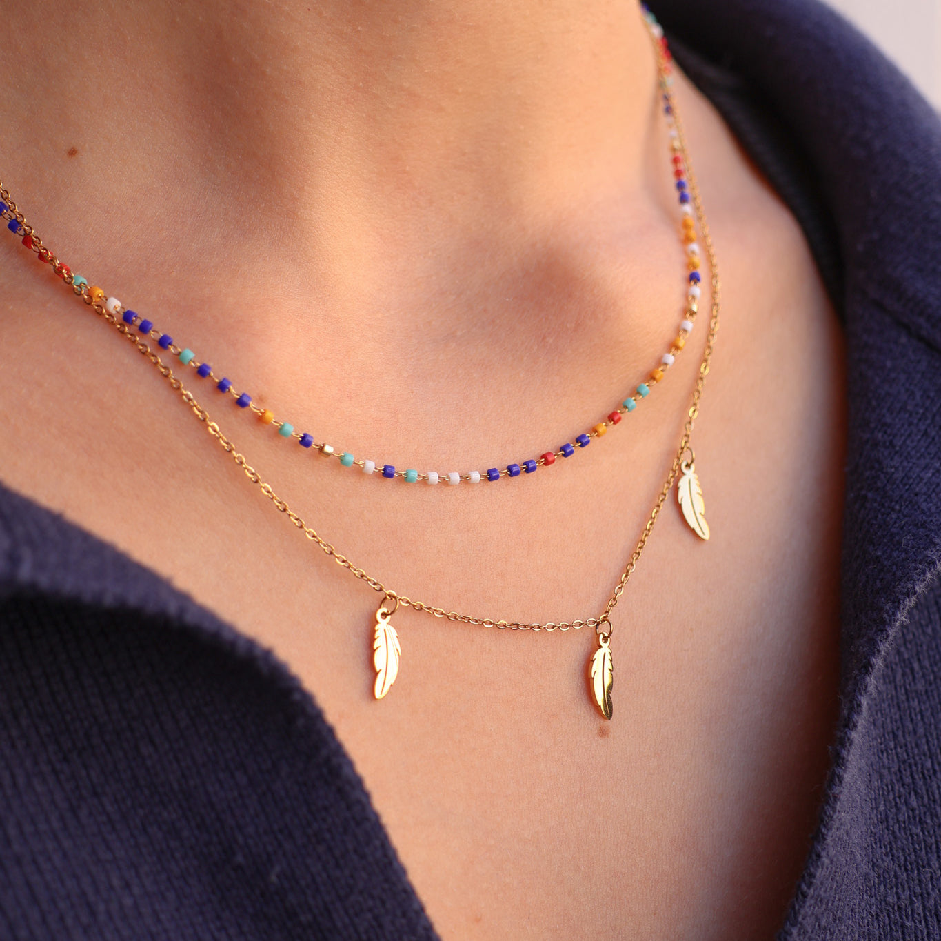 Double row Sara necklace with multicolored beads and stainless steel feather tassels