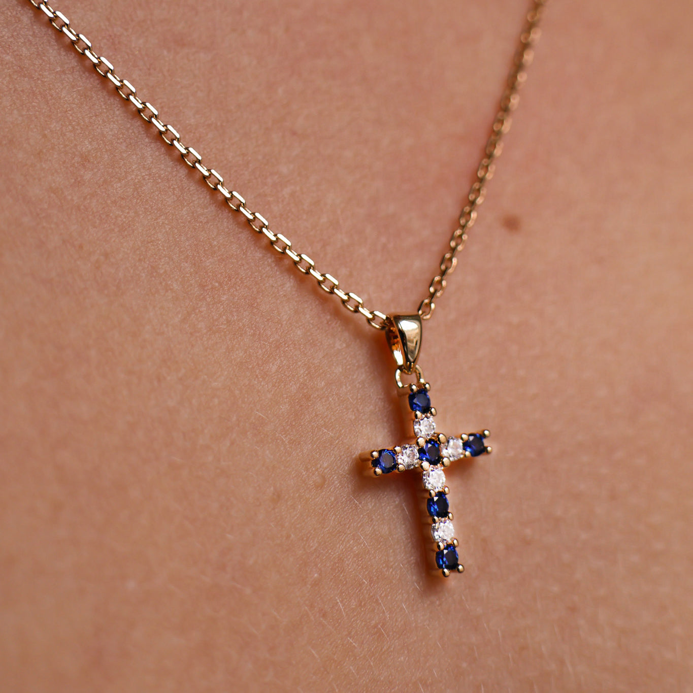 Gold-plated blue and white oxide cross pendant