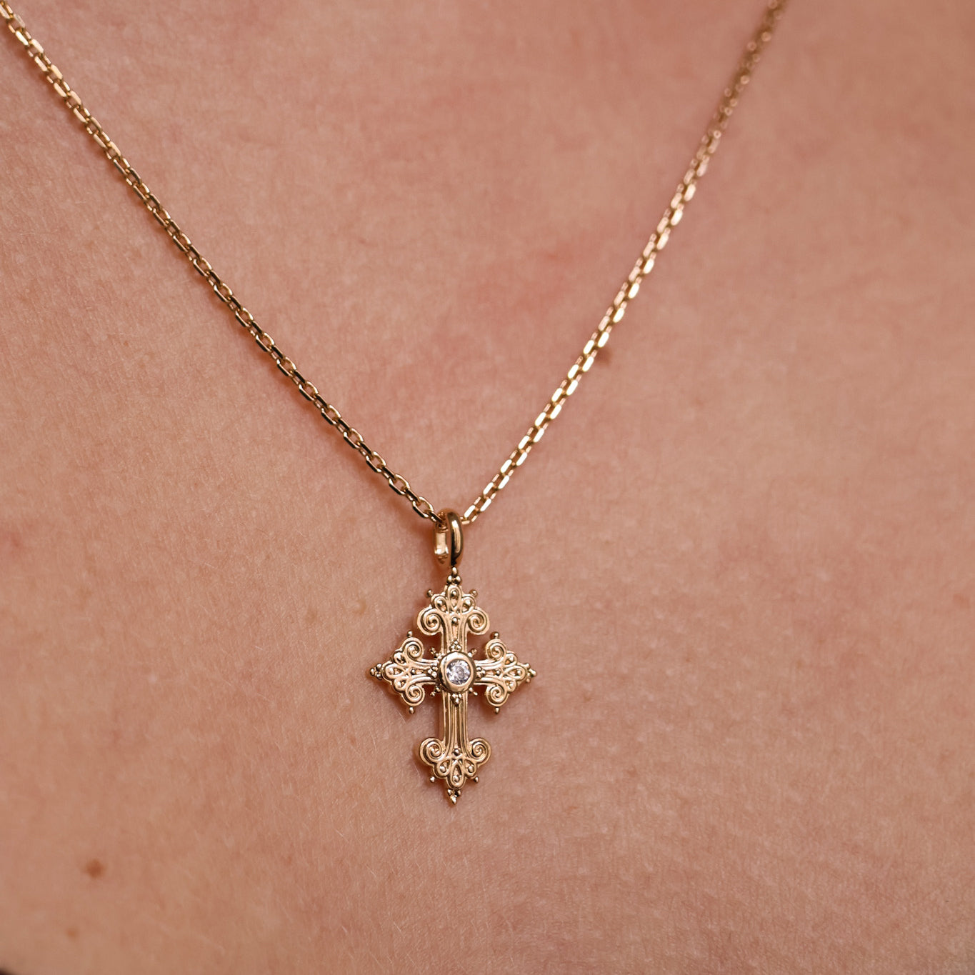 Stylized oxide and gold-plated cross pendant