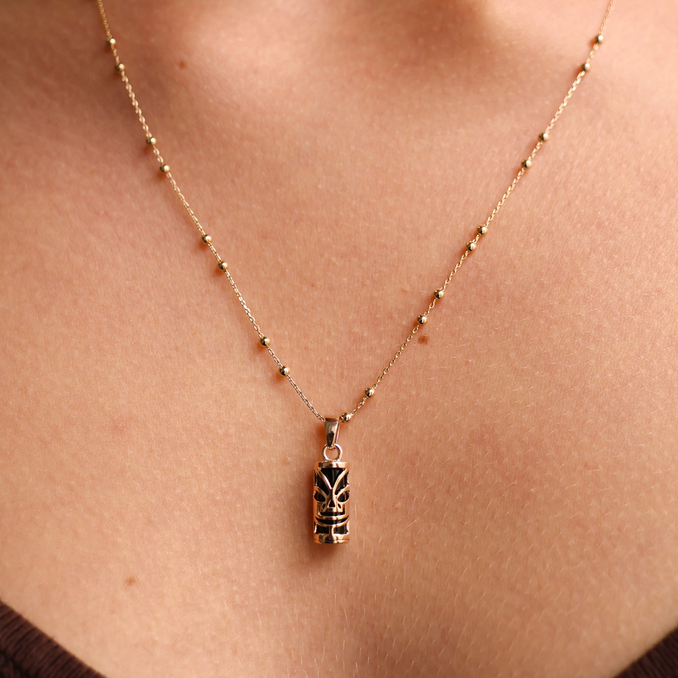 Polynesian Tiki pendant 5x10mm with gold plated onyx